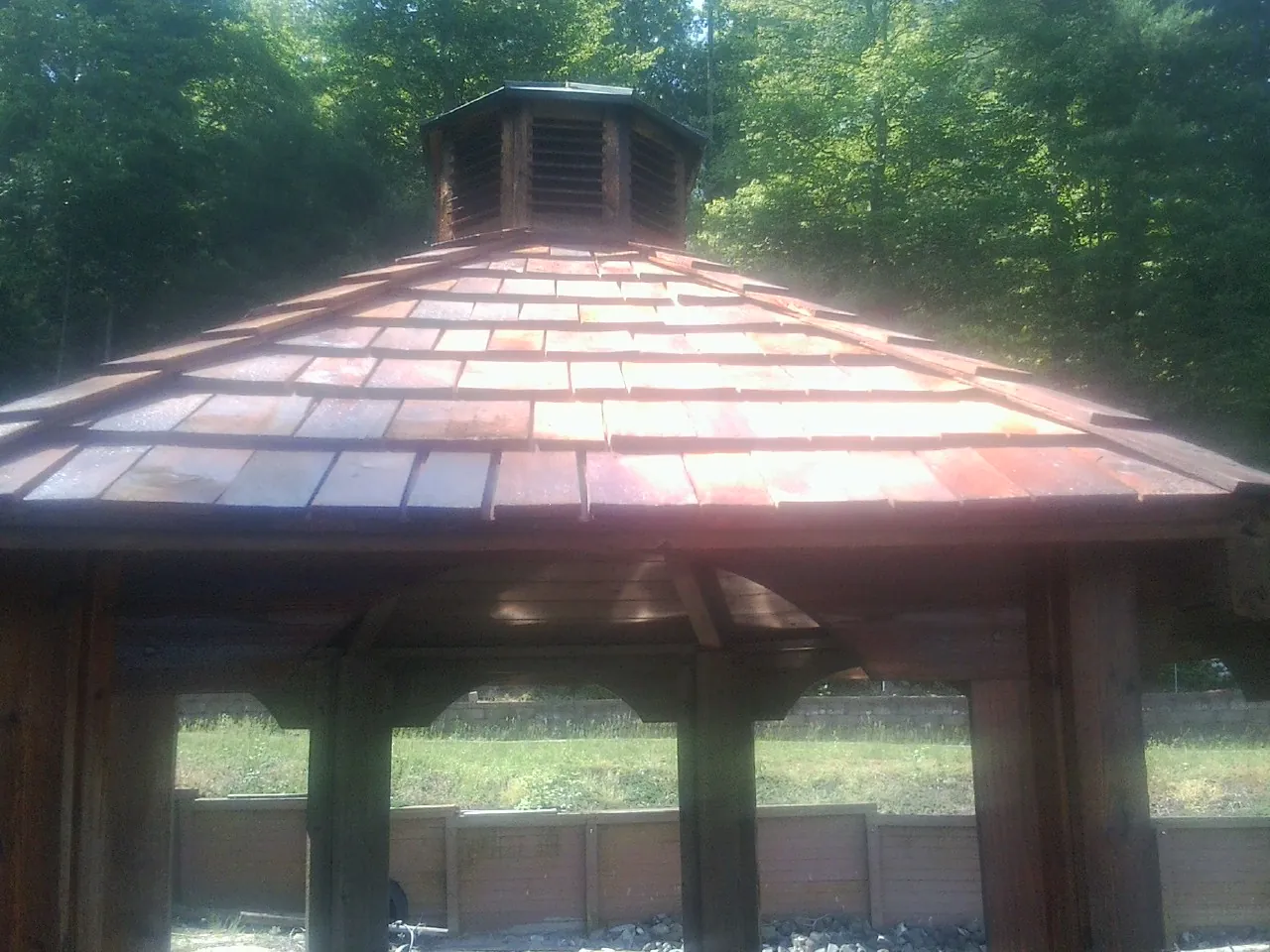 New cedar shake roof and cupola on a lakeside gazebo in Brunsville